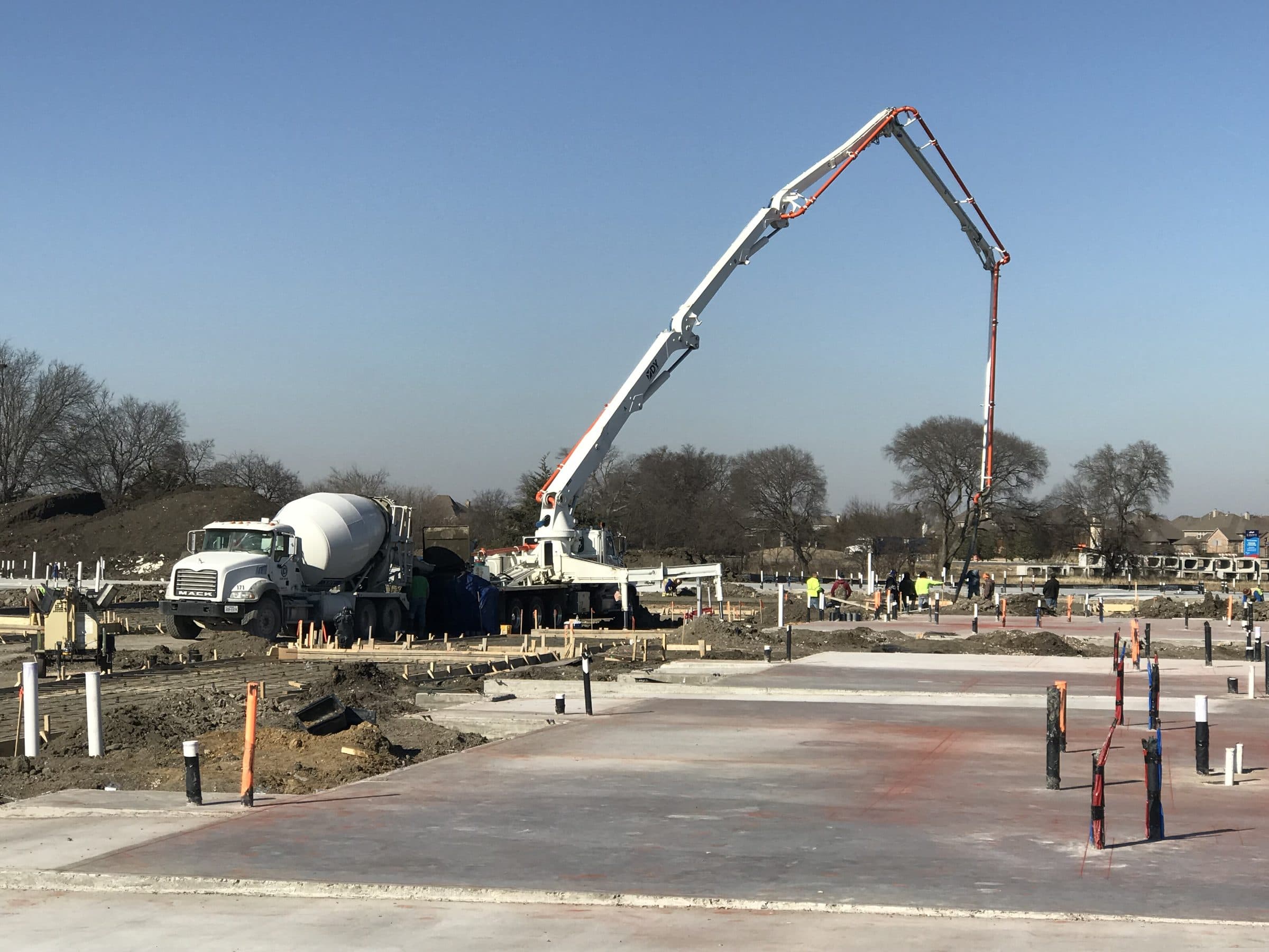 A concrete boom pump placing a building slab