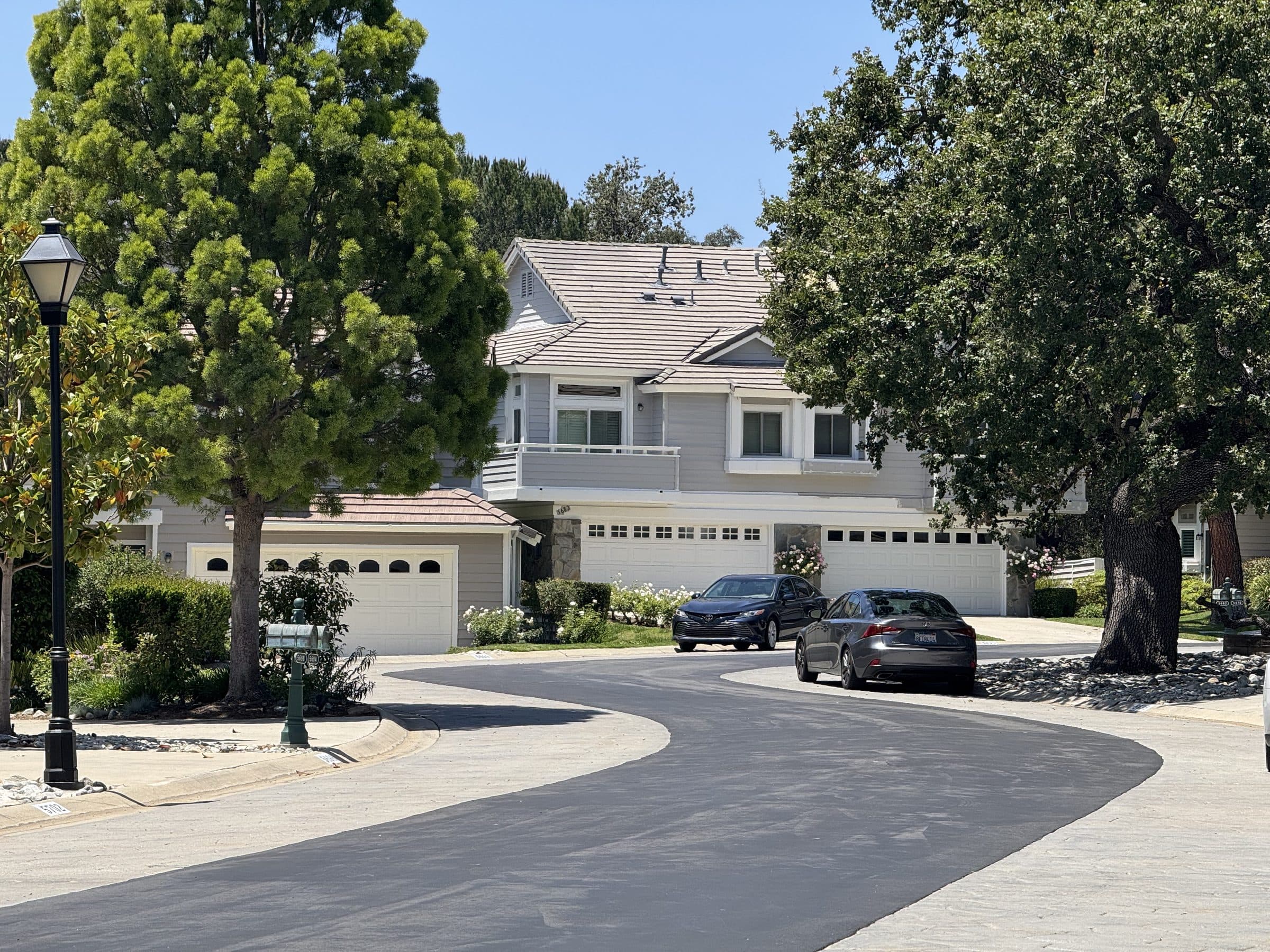Two-story townhomes with paired garages and mature planting