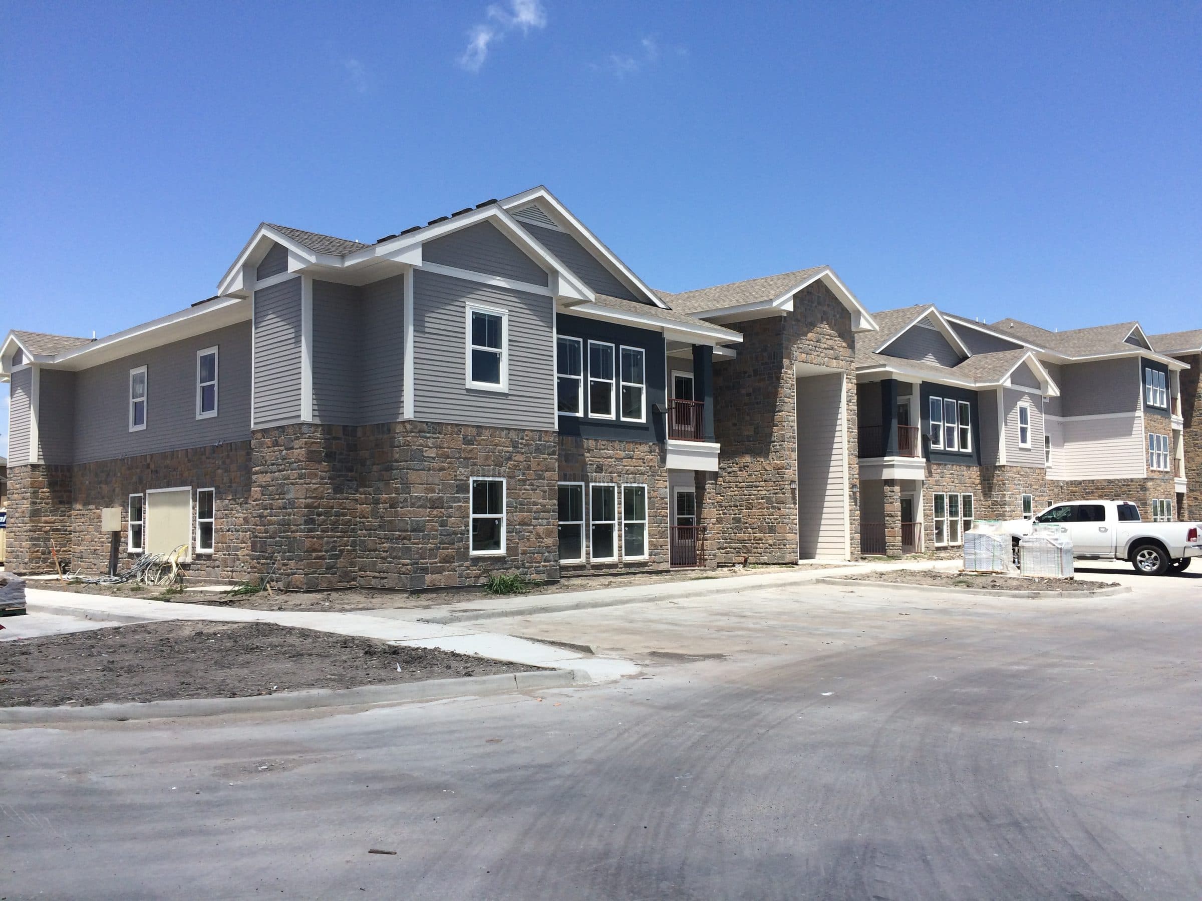 The completed two-story stone and siding elevation